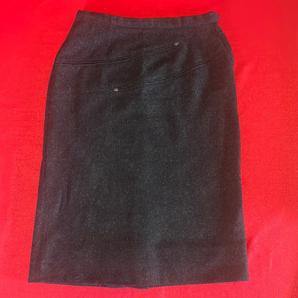 Vintage black virgin wool pencil skirt w/ side zipper and hook and eye closure.